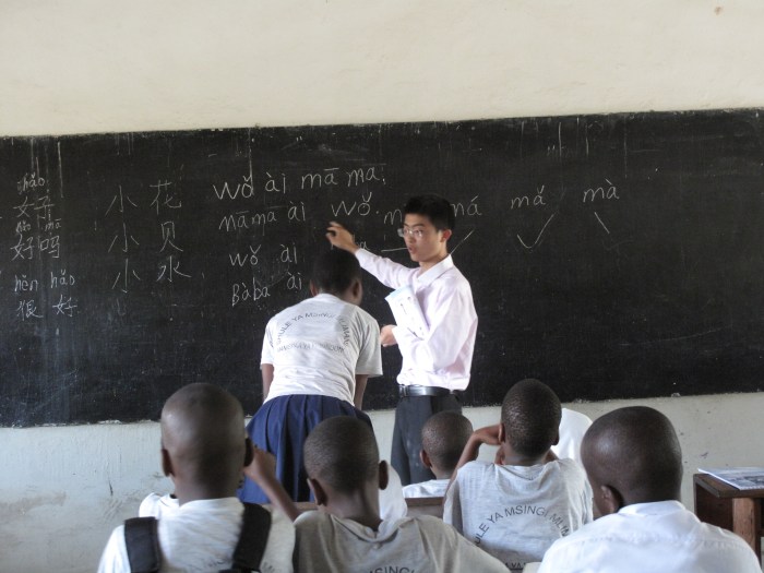 A Chinese graduate gives Tanzanian children their very first Chinese lesson in a Dar Es Salaam school in Tanzania